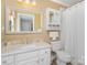 A well-lit bathroom features a stylish vanity with marble countertops and a shower with a white curtain at 118 Sunrise Cir, Mooresville, NC 28117