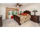 A stylish bedroom showcasing elegant furniture, a patterned bedspread, and a view of the outdoor scenery at 118 Sunrise Cir, Mooresville, NC 28117