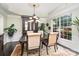 Elegant dining room featuring a large window, chandelier, hardwood floors, and custom built-in cabinet at 118 Sunrise Cir, Mooresville, NC 28117