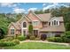 Charming two-story brick home with a beautifully manicured lawn and mature trees, offering great curb appeal and a welcoming ambiance at 118 Sunrise Cir, Mooresville, NC 28117