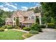 Charming brick home features a manicured front lawn, mature trees, and inviting landscaping, creating a warm and welcoming atmosphere at 118 Sunrise Cir, Mooresville, NC 28117