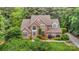 Beautiful brick home boasts lush landscaping, a well-manicured lawn, and mature trees, offering great curb appeal and a private setting at 118 Sunrise Cir, Mooresville, NC 28117