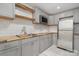 Modern kitchen with gray cabinets, stainless steel appliances, butcher block counters, and subway tile backsplash at 118 Sunrise Cir, Mooresville, NC 28117