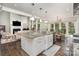 Open-concept kitchen island with granite countertops, pendant lighting, and seamless flow into the living room at 118 Sunrise Cir, Mooresville, NC 28117