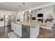 Open-concept kitchen island with granite countertops, stainless steel appliances, and custom cabinets at 118 Sunrise Cir, Mooresville, NC 28117