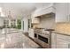 Gourmet kitchen featuring stainless steel appliances, granite countertops, and custom tile backsplash at 118 Sunrise Cir, Mooresville, NC 28117