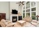 Bright living room with a fireplace, large windows offering natural light, and comfortable seating, perfect for relaxation at 118 Sunrise Cir, Mooresville, NC 28117