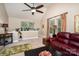 Cozy living room with vaulted ceiling, a ceiling fan, and a comfortable leather sofa at 118 Sunrise Cir, Mooresville, NC 28117