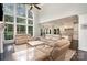 Open-concept living area with high ceilings, large windows, and comfortable furniture, seamlessly connected to the modern kitchen at 118 Sunrise Cir, Mooresville, NC 28117