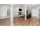 A spacious living room with wood floors, a fireplace, and access to the outdoors through double doors at 118 Sunrise Cir, Mooresville, NC 28117