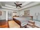 Cozy bedroom with hardwood floors, tray ceiling, ceiling fan, and ensuite bath access at 118 Sunrise Cir, Mooresville, NC 28117