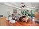 Spacious bedroom with hardwood floors, tray ceiling, ceiling fan, and large windows at 118 Sunrise Cir, Mooresville, NC 28117