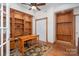 A cozy home office featuring hardwood floors, custom built-in shelving, and ample natural light at 118 Sunrise Cir, Mooresville, NC 28117