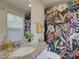 Bright bathroom featuring granite countertops, a decorative floral shower curtain, and a large mirror at 1209 Gaston Ave, Gastonia, NC 28052