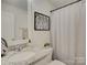 Bathroom featuring a large mirror, granite countertops, and decorative shower curtain at 1209 Gaston Ave, Gastonia, NC 28052