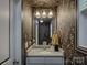 Stylish half bathroom featuring floral wallpaper, granite countertop, and modern lighting fixture at 1209 Gaston Ave, Gastonia, NC 28052