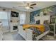 Comfortable bedroom featuring bright natural light, ceiling fan, and striking decorative wall at 1209 Gaston Ave, Gastonia, NC 28052