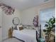 Well-lit bedroom featuring a comfy bed, decorative plants, and a stylish mirror at 1209 Gaston Ave, Gastonia, NC 28052