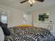 Cozy bedroom featuring a large dresser and a ceiling fan with a unique bed spread at 1209 Gaston Ave, Gastonia, NC 28052