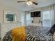 Cozy main bedroom featuring a decorative accent wall, ceiling fan, and neutral color palette at 1209 Gaston Ave, Gastonia, NC 28052