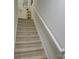 Carpeted staircase with white railing leading to the upper level at 1209 Gaston Ave, Gastonia, NC 28052