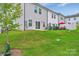 Backyard of the townhome featuring a well-manicured lawn, patio area, privacy fence, and outdoor seating at 12110 Chesapeake Mallard Dr, Charlotte, NC 28262