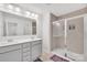 Modern bathroom with double vanity, large mirror, and glass-enclosed shower at 12110 Chesapeake Mallard Dr, Charlotte, NC 28262