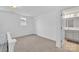Bright bedroom featuring neutral carpet, ample natural light, and en-suite bathroom access at 12110 Chesapeake Mallard Dr, Charlotte, NC 28262