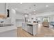 Bright kitchen features stainless steel appliances, white cabinets, island with seating, and an open layout at 12110 Chesapeake Mallard Dr, Charlotte, NC 28262