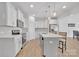 Modern kitchen with white cabinetry, stainless steel appliances, pendant lighting, and an island with seating at 12110 Chesapeake Mallard Dr, Charlotte, NC 28262