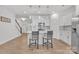 Stylish kitchen with white cabinets, stainless steel appliances, an island with barstools, and open access to living spaces at 12110 Chesapeake Mallard Dr, Charlotte, NC 28262