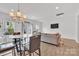 Open living area with a dining table, modern sofa, TV, and sliding doors leading to the outdoor space at 12110 Chesapeake Mallard Dr, Charlotte, NC 28262