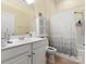 Well-lit bathroom featuring a vanity, toilet, and shower with patterned curtain at 1219 Crown Vista Dr, Fort Mill, SC 29707