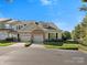 Attractive townhome with two-car garage, stone accents, well-kept lawn and mature landscaping at 1219 Crown Vista Dr, Fort Mill, SC 29707