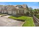 Beautiful townhome featuring a two car garage, stone details, and a pristine lawn at 1219 Crown Vista Dr, Fort Mill, SC 29707