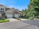 Charming townhome featuring a stone facade, two-car garage, and well-maintained landscaping at 1219 Crown Vista Dr, Fort Mill, SC 29707
