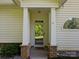 Elegant front entry with classic columns and a charming arched window creating a welcoming entrance at 1219 Crown Vista Dr, Fort Mill, SC 29707