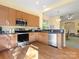 Bright kitchen featuring wood cabinets, stainless appliances, and an open floor plan to the dining area at 1219 Crown Vista Dr, Fort Mill, SC 29707