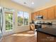 Bright kitchen featuring wood cabinets, stainless appliances, and an open view to the backyard at 1219 Crown Vista Dr, Fort Mill, SC 29707