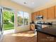 Bright kitchen featuring wood cabinets, stainless appliances, and an open view to the backyard at 1219 Crown Vista Dr, Fort Mill, SC 29707