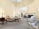 Comfortable living room featuring a fireplace, neutral colors, and an open floor plan to the dining area at 1219 Crown Vista Dr, Fort Mill, SC 29707