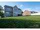 Expansive backyard with lush green lawn and a charming wooden deck, perfect for outdoor entertaining and relaxation at 126 W Warfield Dr, Mooresville, NC 28115