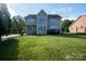 Spacious backyard with a lush lawn and a view of the home's exterior at 126 W Warfield Dr, Mooresville, NC 28115