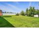 Expansive backyard featuring a well-maintained lawn, privacy fence, and mature trees offering shade and a serene outdoor space at 126 W Warfield Dr, Mooresville, NC 28115
