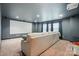 Finished basement with a large screen, projector, and comfortable seating area at 126 W Warfield Dr, Mooresville, NC 28115