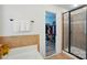 Bathroom includes tiled shower, soaking tub, linen closet and doorway to large walk-in closet at 126 W Warfield Dr, Mooresville, NC 28115