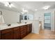 Well-lit bathroom with double vanity, dark wood cabinets, soaking tub, and separate shower at 126 W Warfield Dr, Mooresville, NC 28115