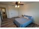 Comfortable bedroom featuring wood-look floors, ceiling fan and plenty of natural light at 126 W Warfield Dr, Mooresville, NC 28115