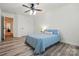 Guest bedroom featuring hard wood floors, ceiling fan, and plenty of natural light at 126 W Warfield Dr, Mooresville, NC 28115