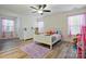 Bright ' bedroom with a ceiling fan, wood-look floors, and a cozy white bed at 126 W Warfield Dr, Mooresville, NC 28115
